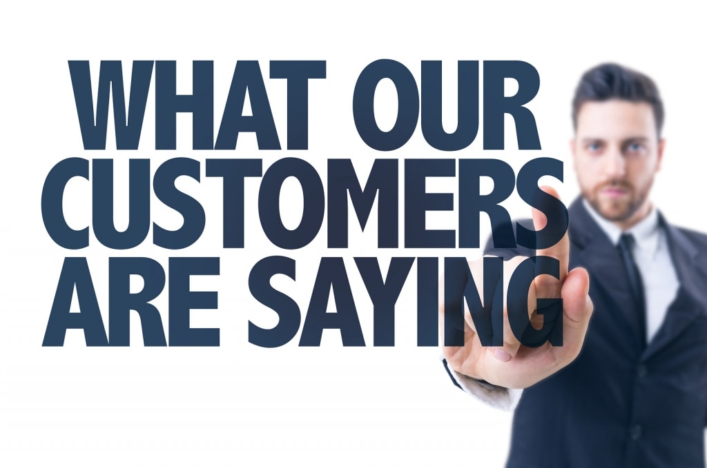 Business man pointing the text: What Our Customers Are Saying