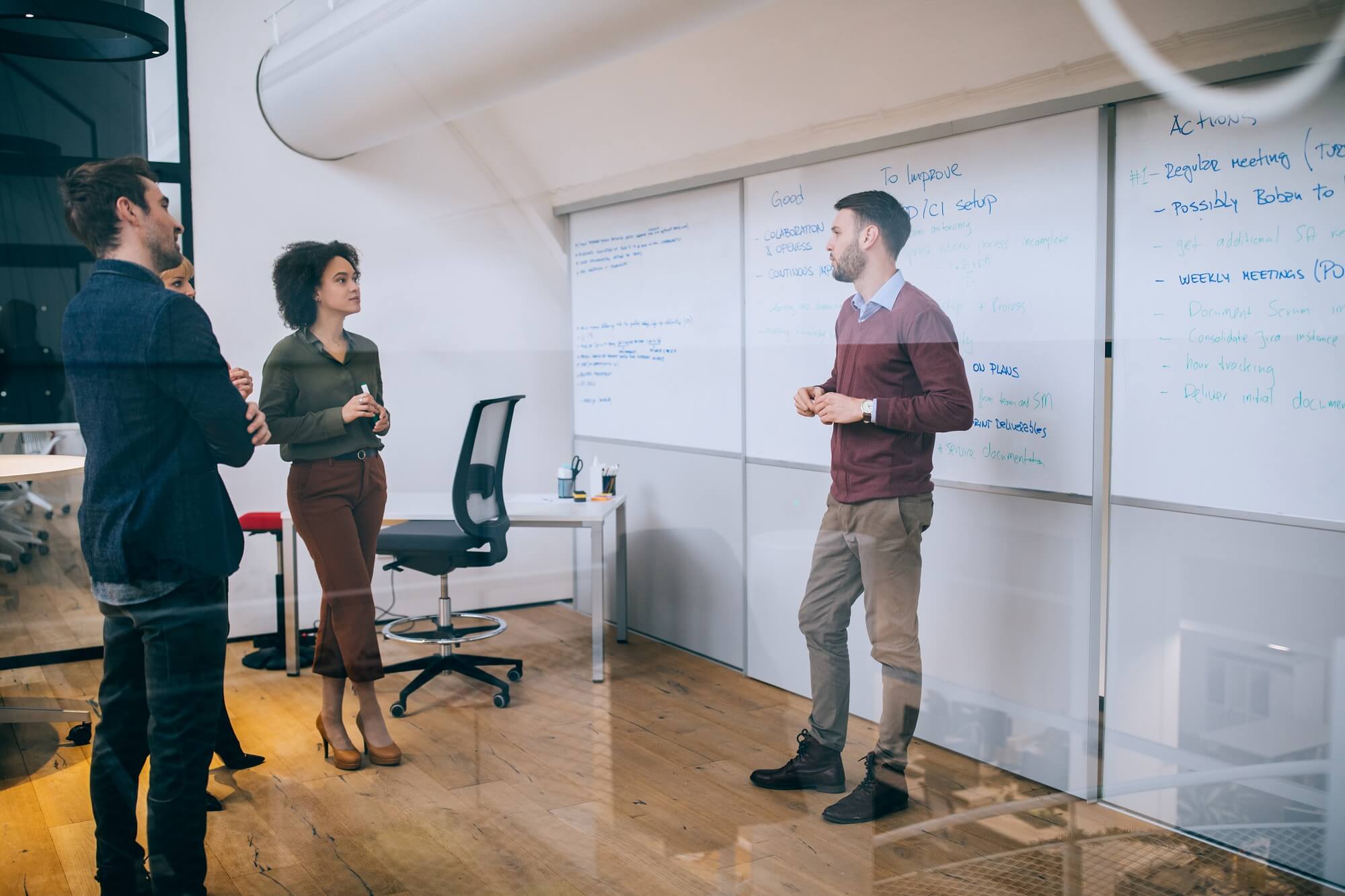 Man giving a presentation to his colleagues in a boardroom