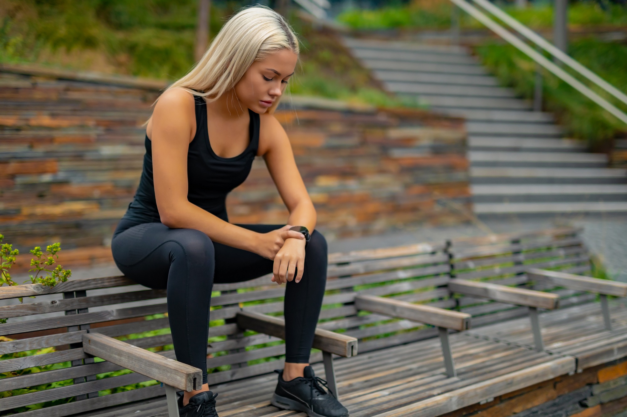 Fitness runner on mobile smart phone app tracking progress for fitness motivation.
