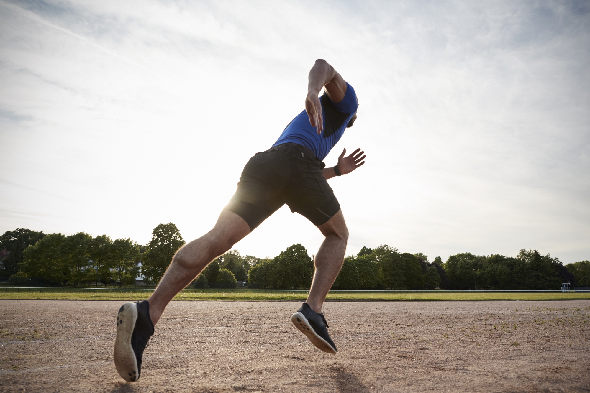 Young male athlete running on a track