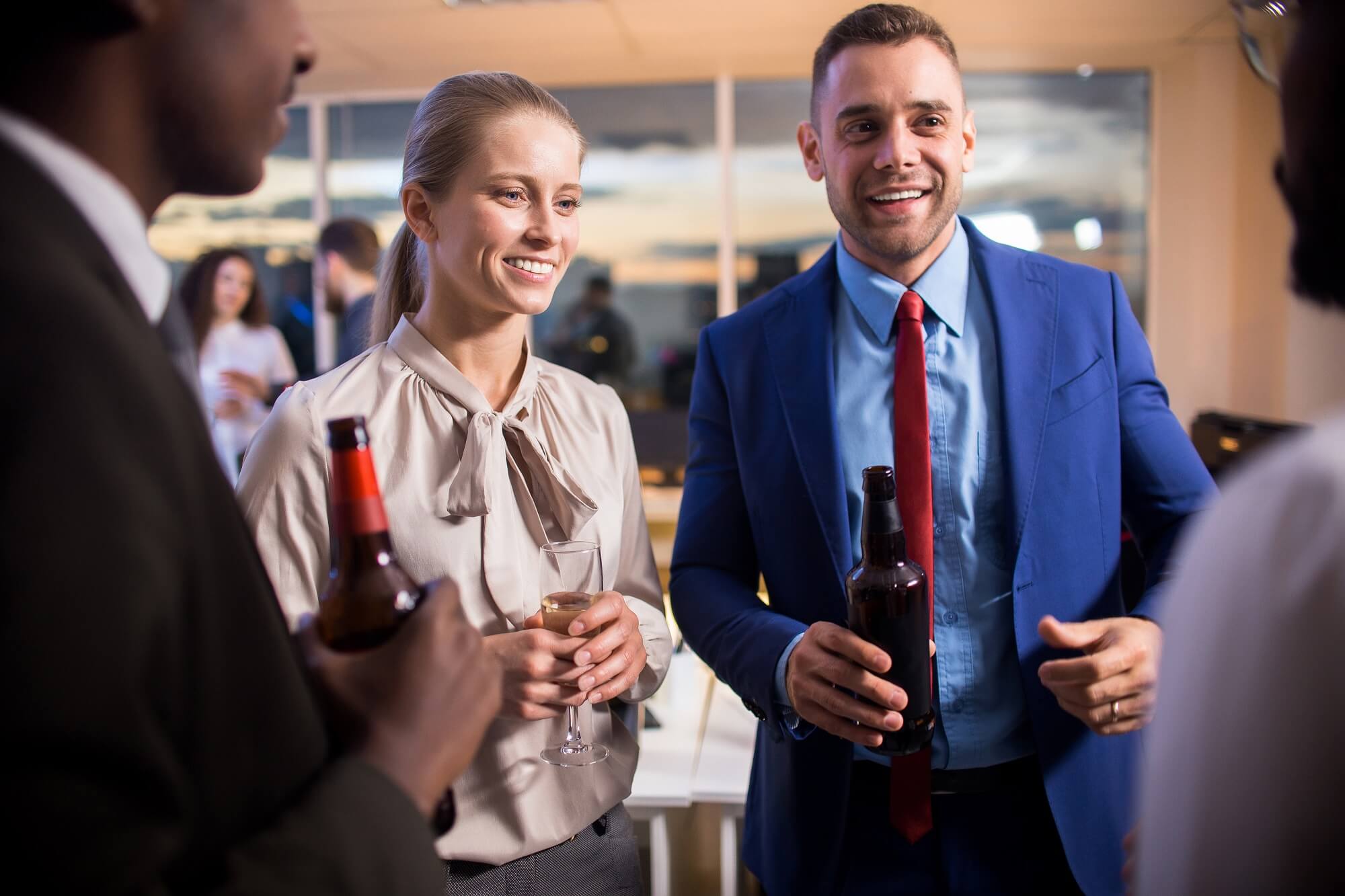 Young successful colleagues drinking at a corporate event party