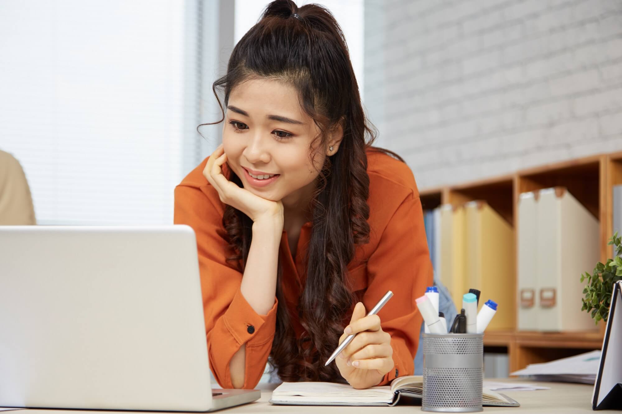 female entrepreneur reading e-mails on laptop 