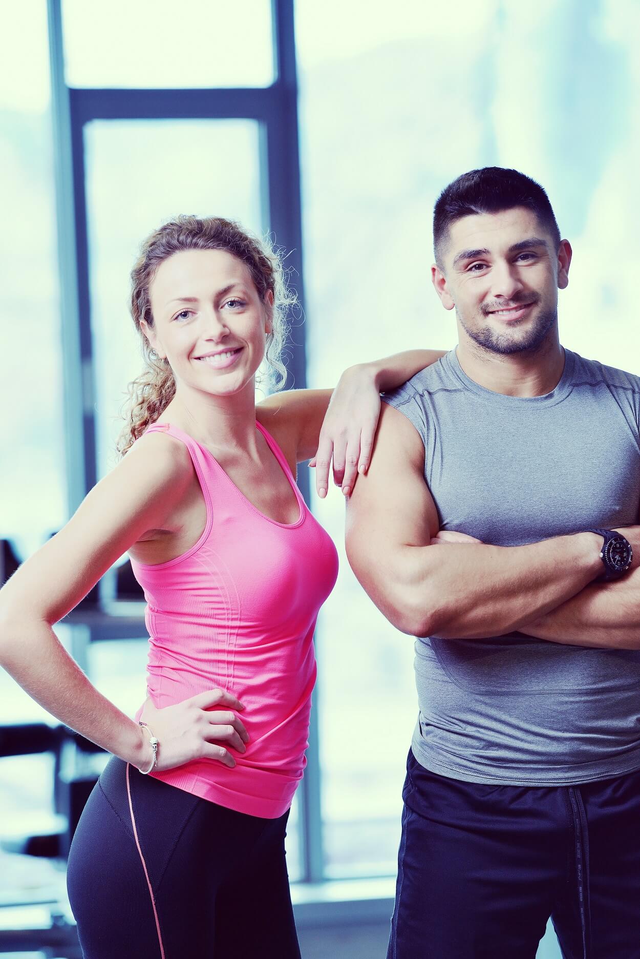 attractive couple at the gym looking happy