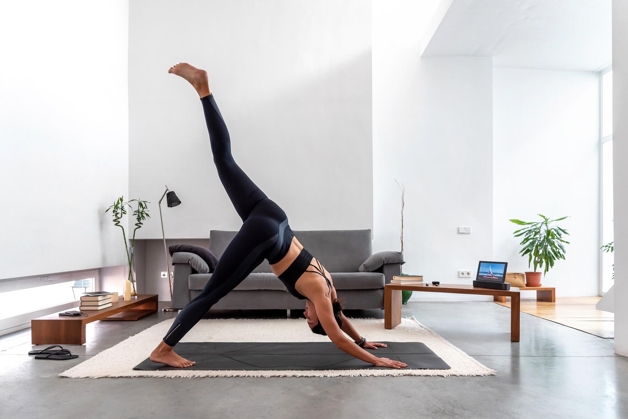 women doing online yoga training program in the tablet at home