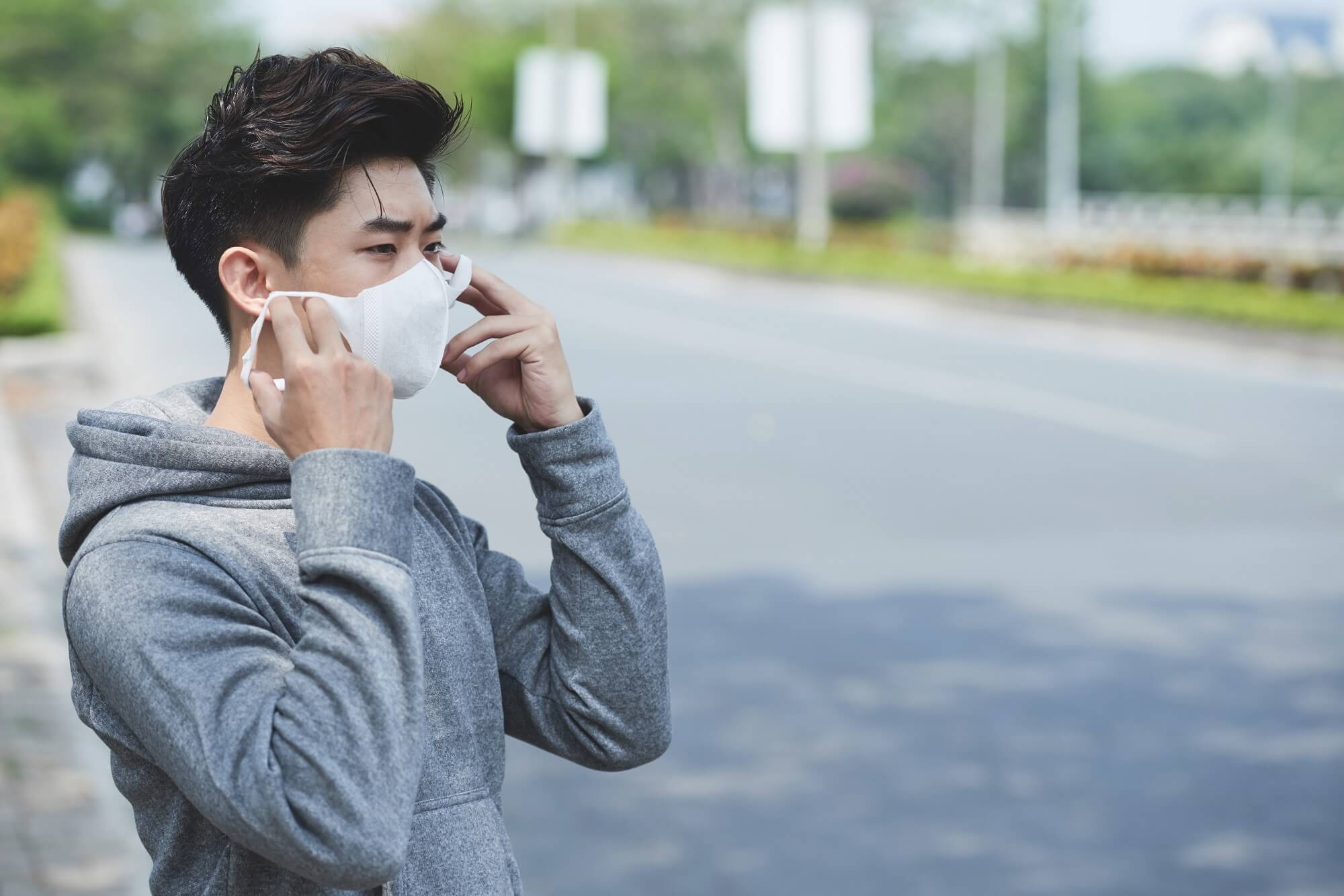 young man wearing face mask to protect himself from viruses