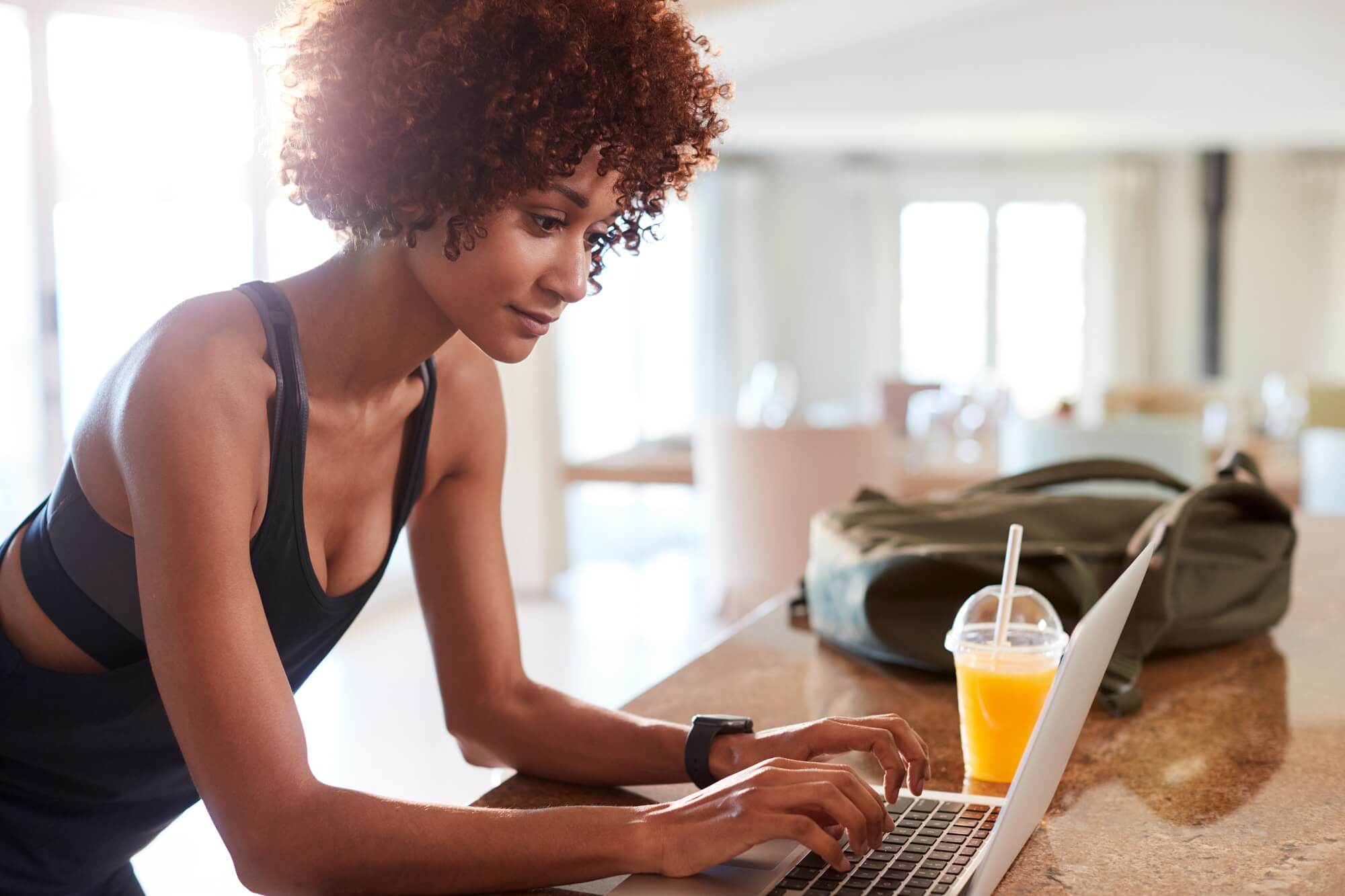 woman checking fitness app wearing a smart watch