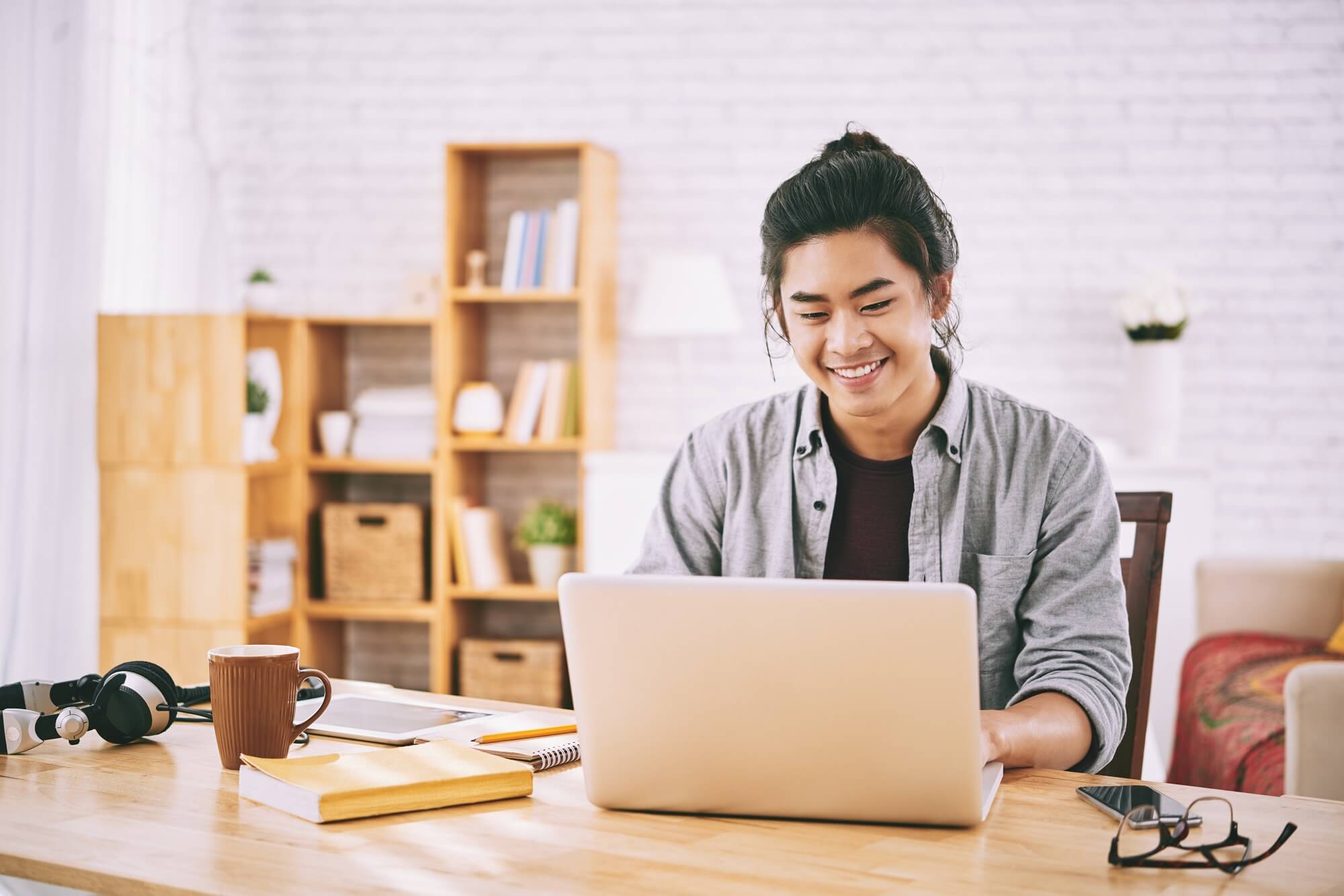 remote worker on laptop at home and excited with his productivity