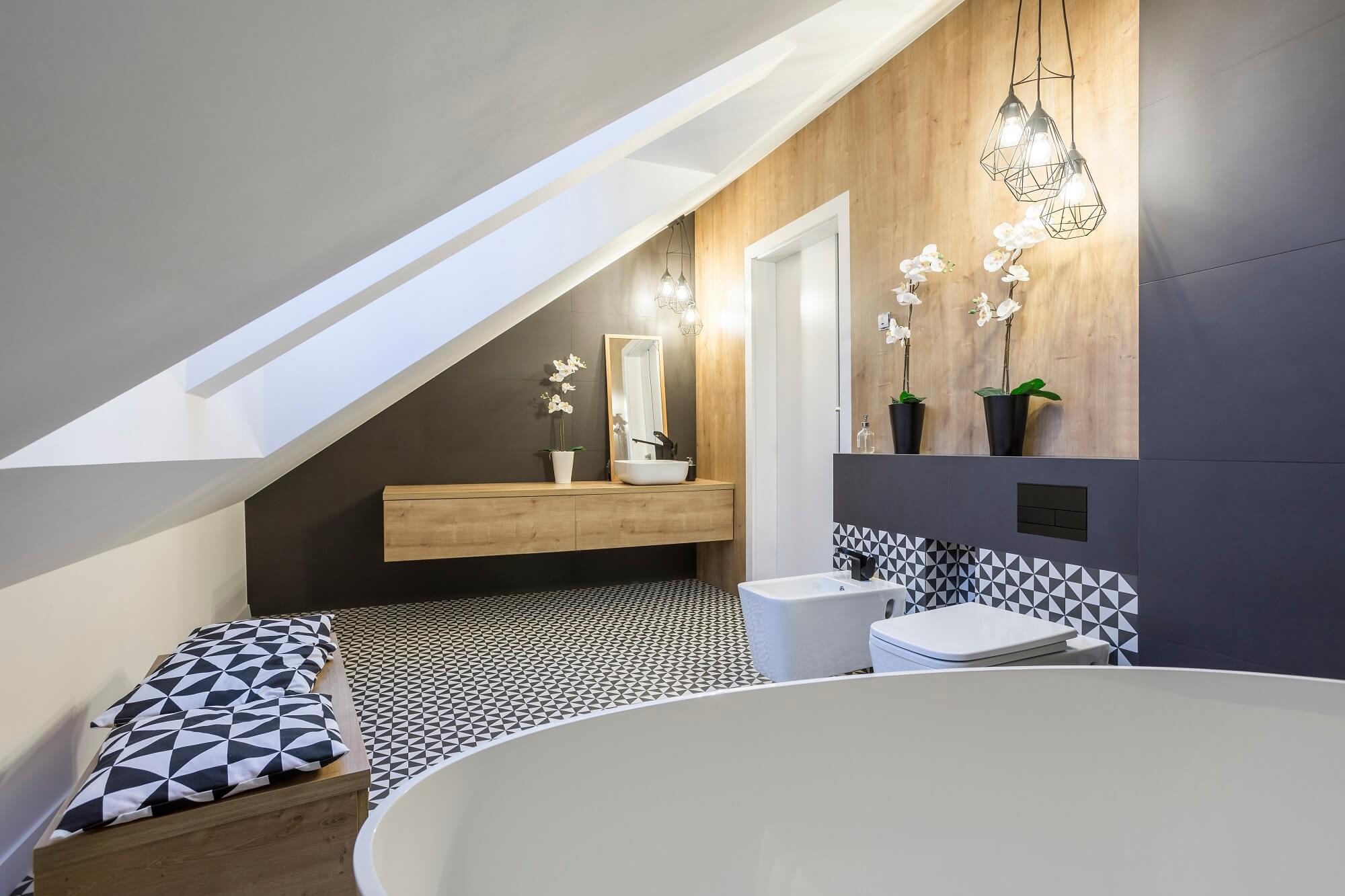 Modernly designed attic bathroom with bathtub