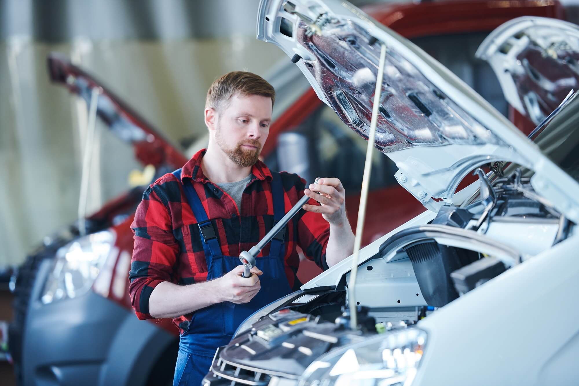 mechanic with hand tool for fixing car problem