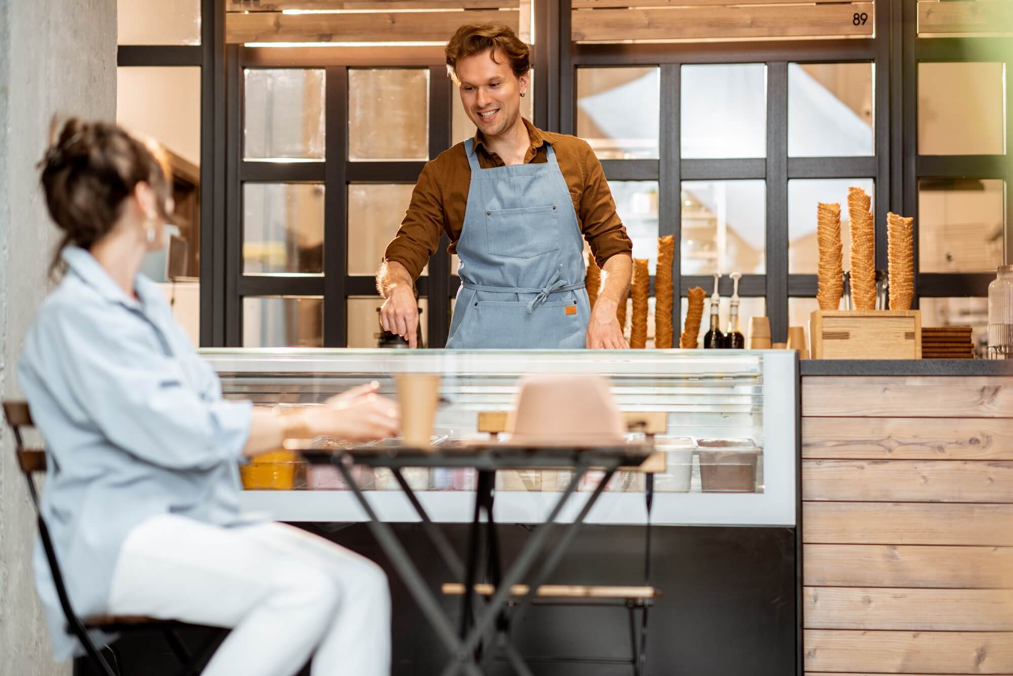 seller client interaction with female customer at the pastry cafe