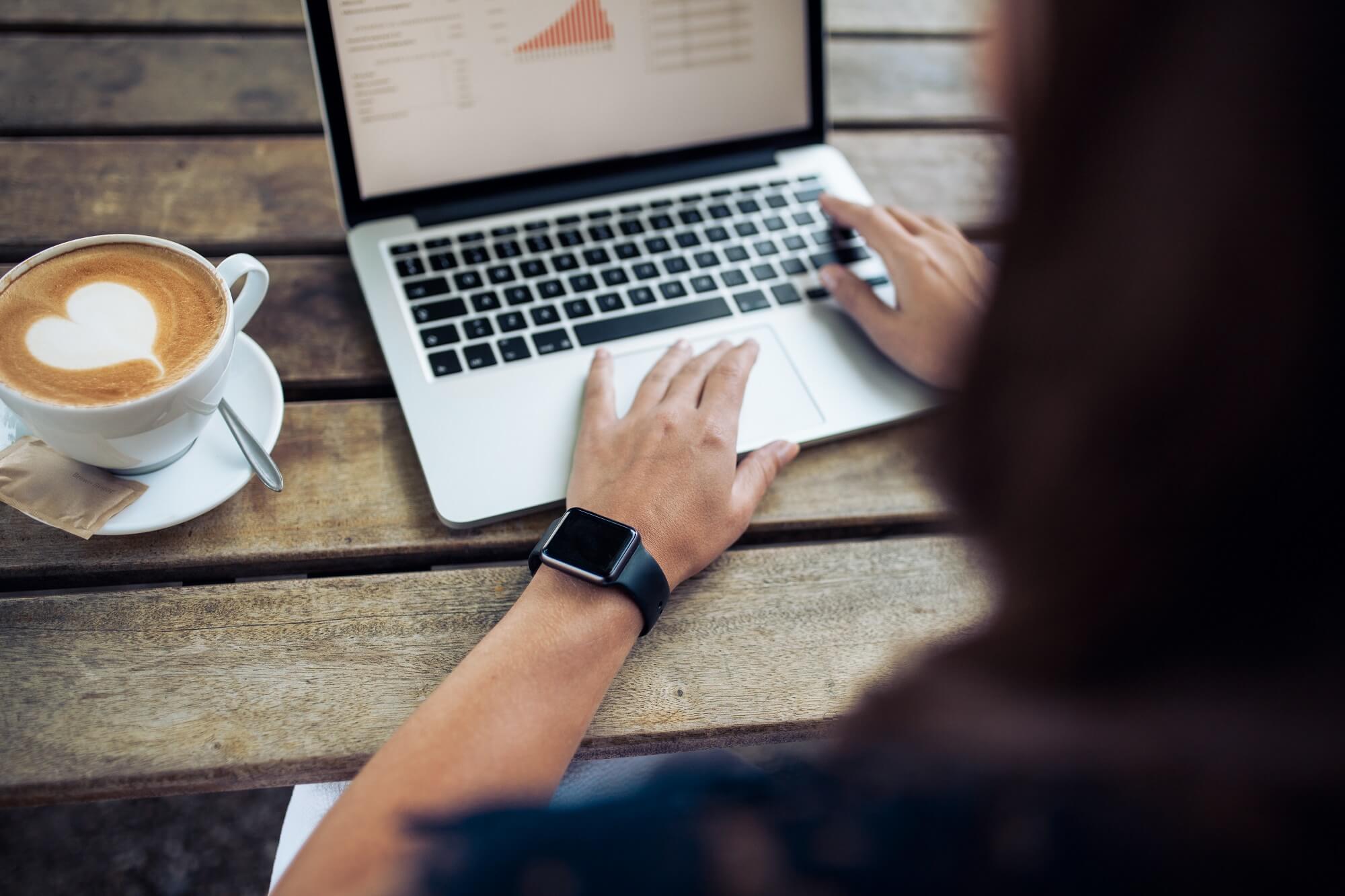 Female wearing a smartwatch at cafe.