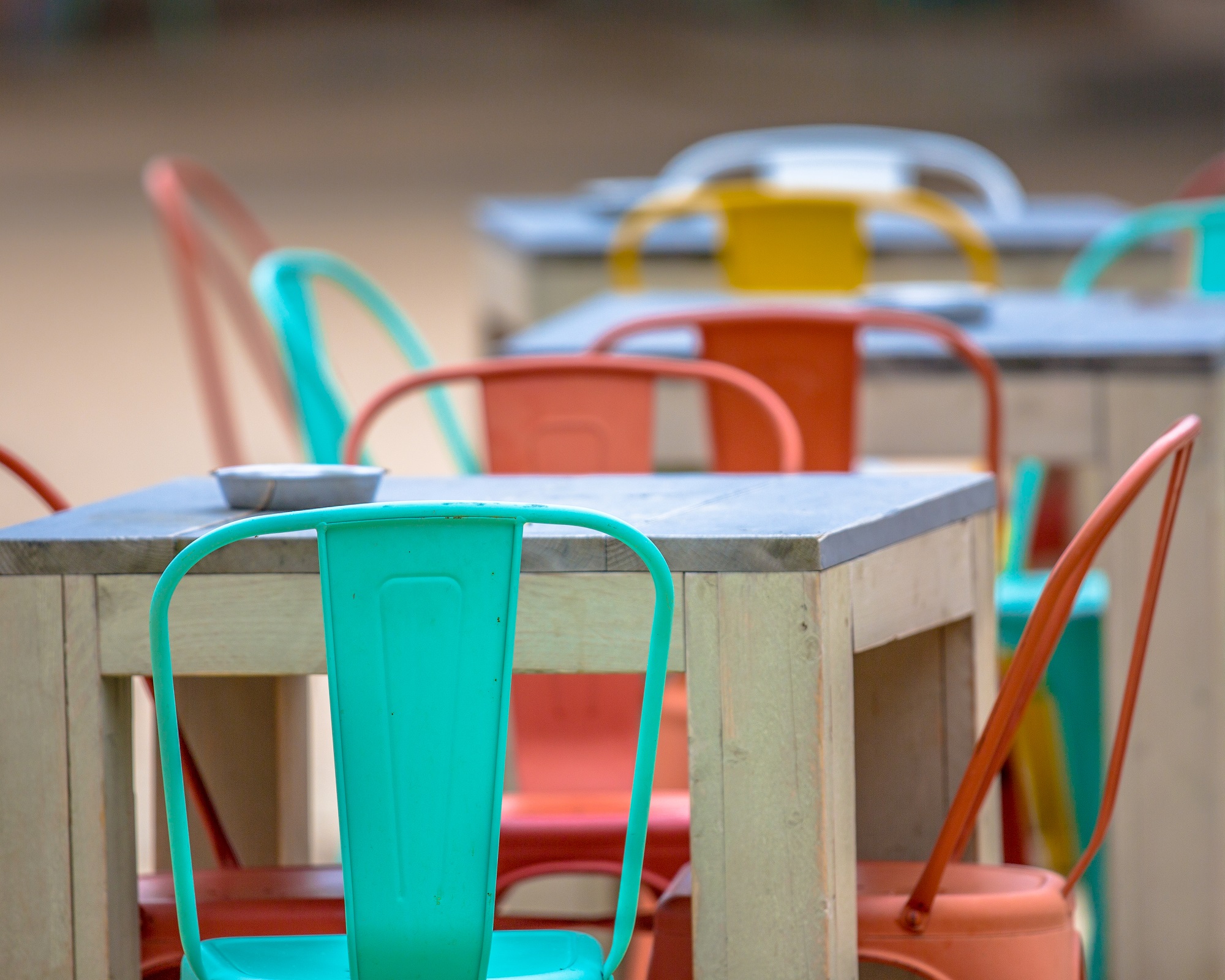 restaurants with outdoor seating with colorful chairs and tables 