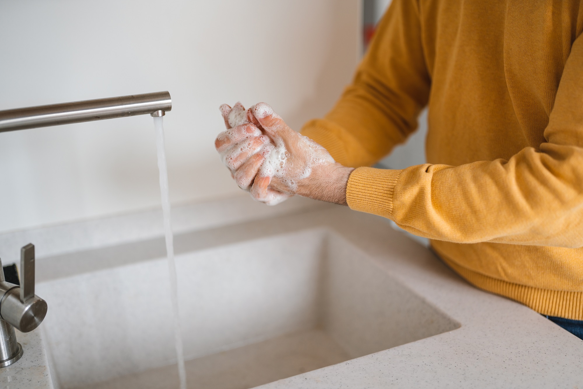 Washing hands rubbing with antibacterial soap man for corona virus prevention