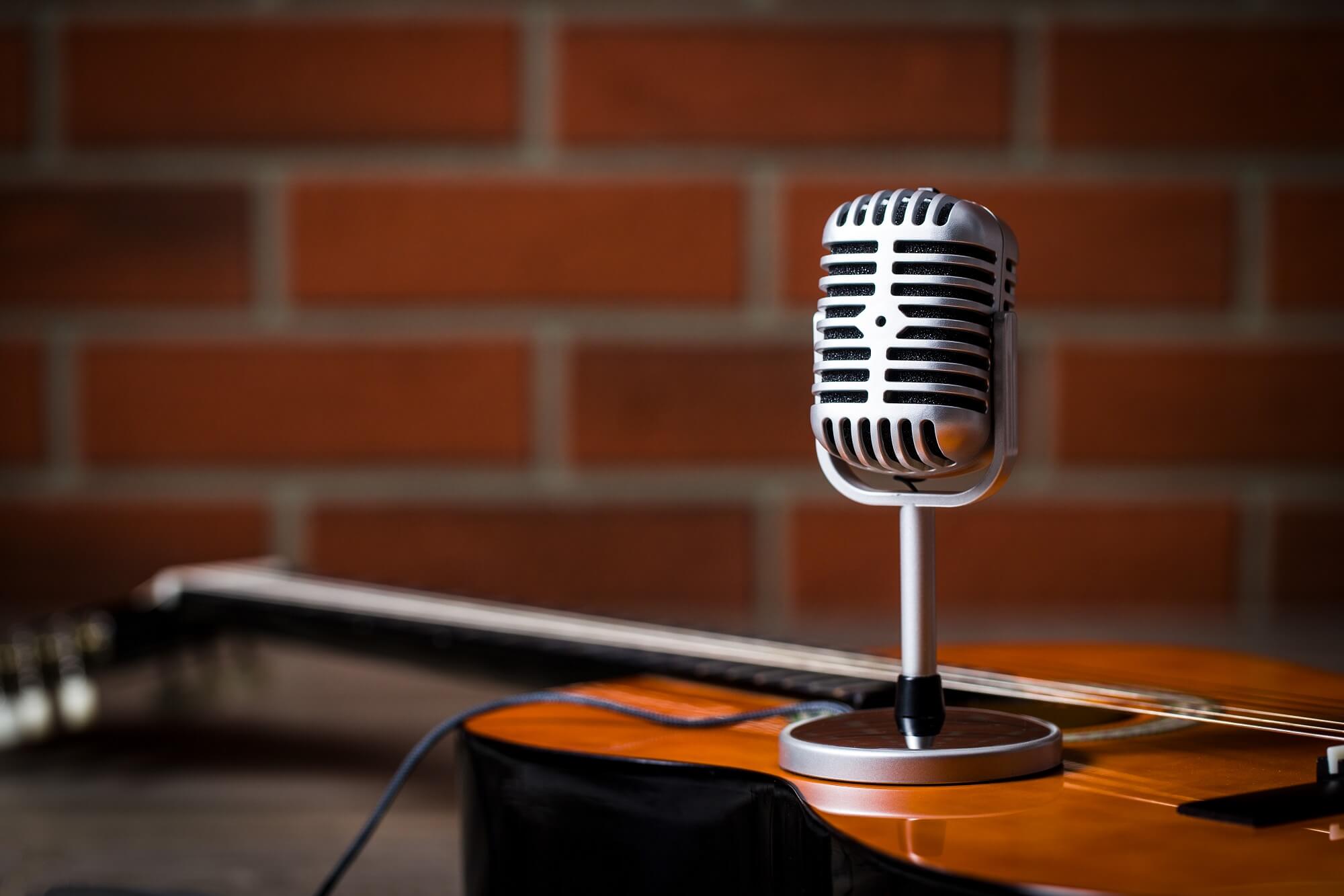 Vintage silver microphone and guitar recording for online singing course 