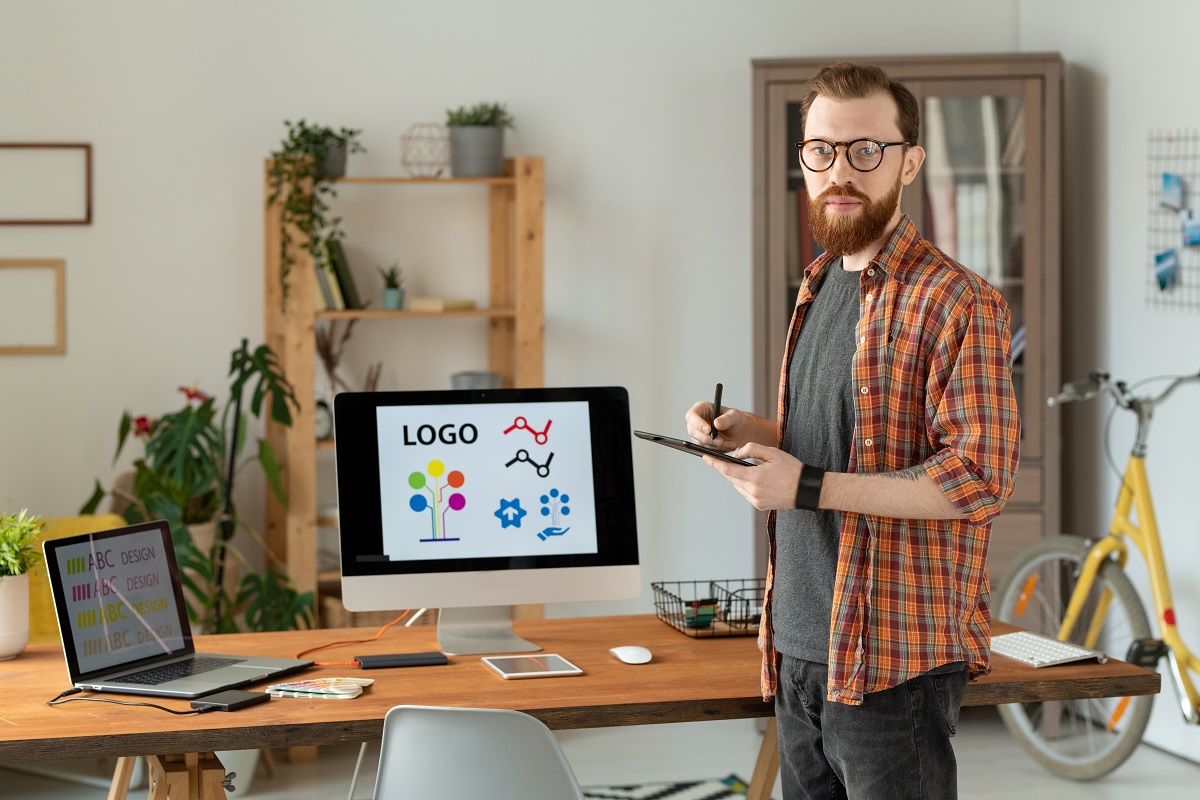 designer working on brand building with beard drawing on digitizer table 