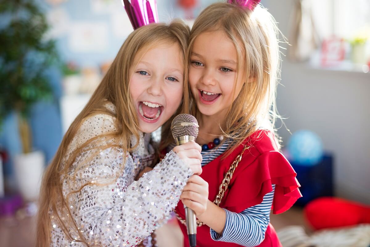 two kids having singing lessons together 