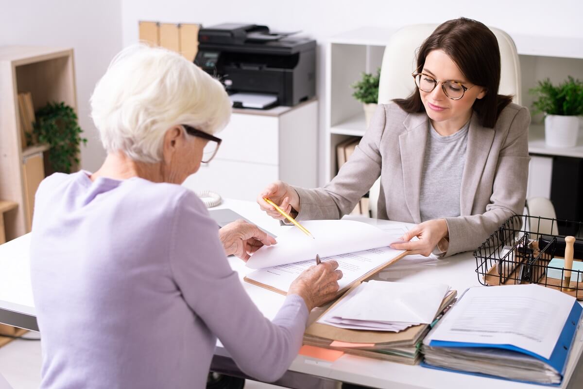  financial adviser working with senior woman giving pension advisers